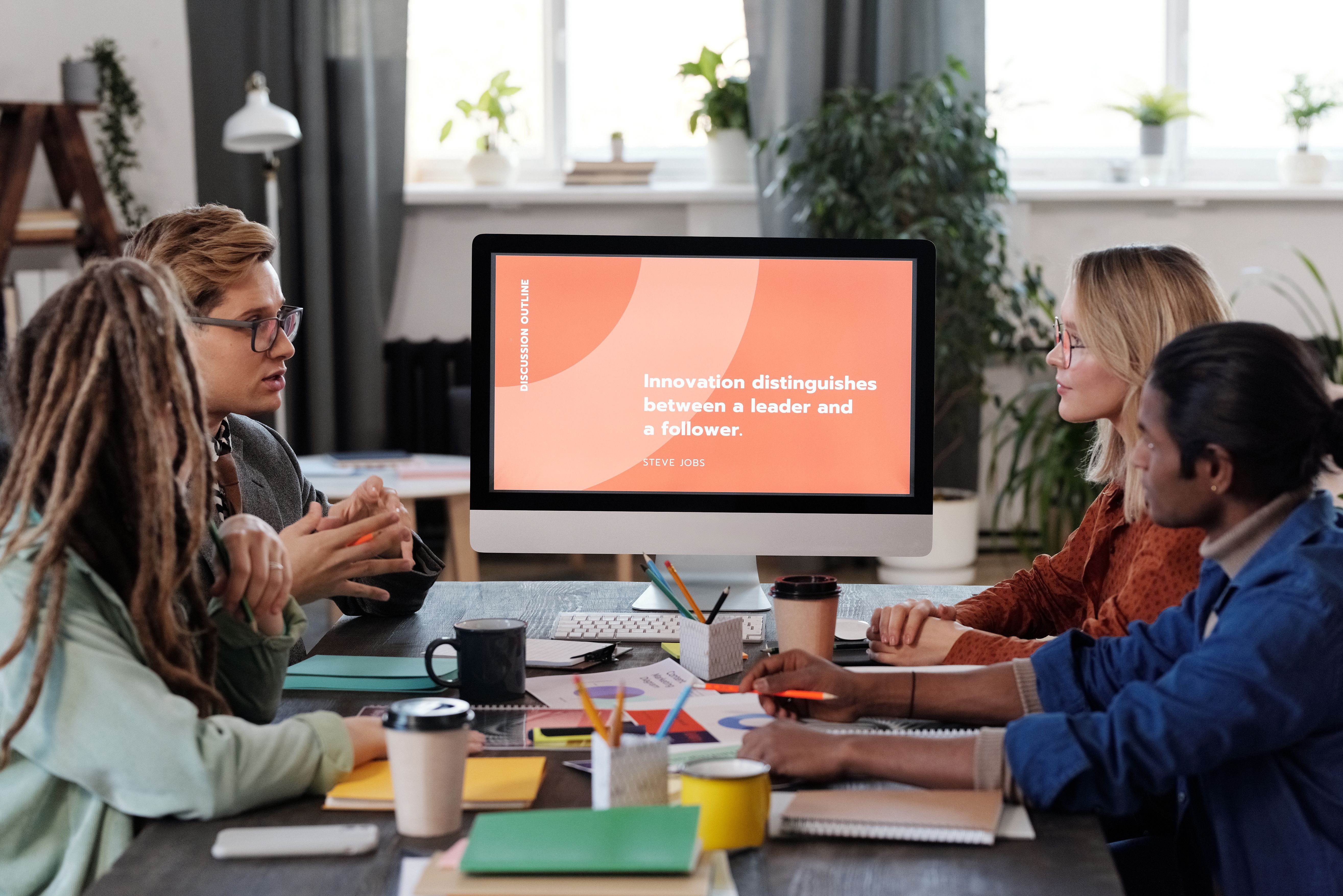 A multicultural team collaborating around a table during a strategy session