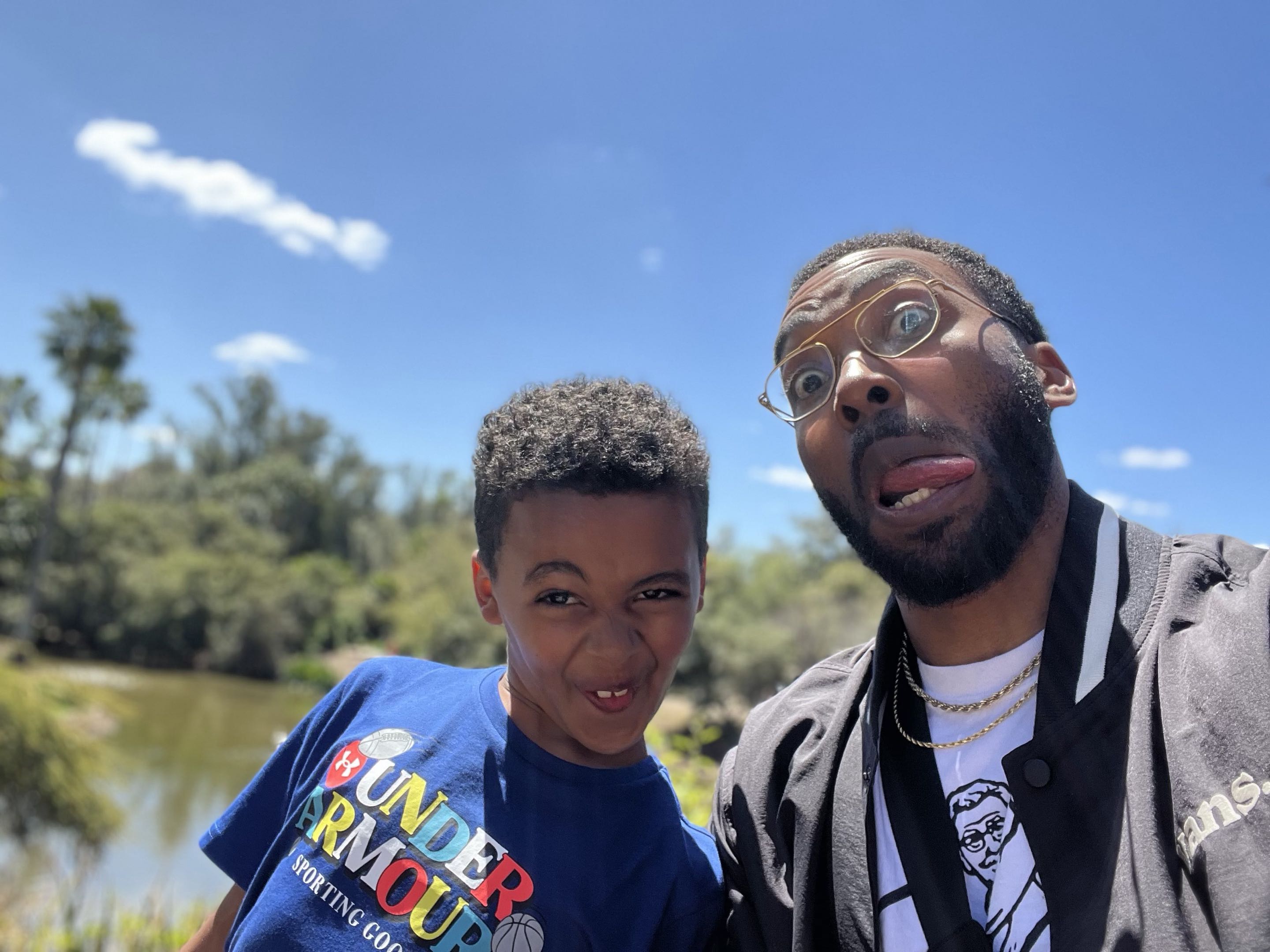 Nigel Benton and his son Liam sharing a playful moment outdoors