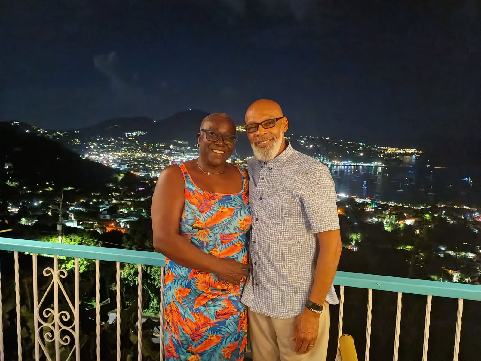 Clyde and Brenda Benton together overlooking a city and harbor at night
